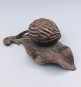 Carved treen fruit wood inkwell in the form of a nut on a leaf