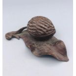 Carved treen fruit wood inkwell in the form of a nut on a leaf