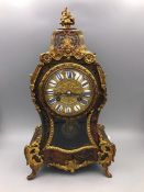 An 18th Century French Boulle Clock with enamel face and gilt decoration.