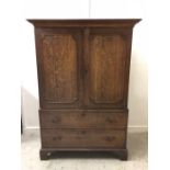 An Oak Linen Press with brass drop handles