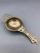 A Silver tea strainer, hallmarked Birmingham 1936.