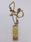 A 9ct yellow gold ingot on chain (33.8g)