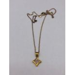 A 14ct yellow gold diamond star shaped pendant necklace