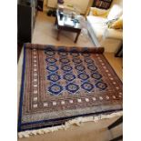 A large blue and brown rug 260cm x 190cm (Made in Pakistan)