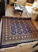 A large blue and brown rug 260cm x 190cm (Made in Pakistan)