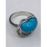 A silver and CZ heart shaped turquoise set dress ring