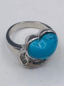 A silver and CZ heart shaped turquoise set dress ring