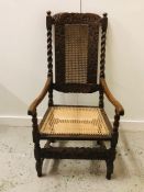 A High Back Walnut carver chair with caned seat and scrolled arms.