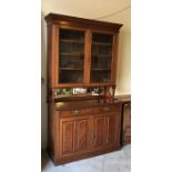 A Mahogany bookcase with mirrored back.