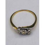 An 18ct yellow gold three stone diamond ring