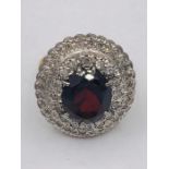 A Yellow gold impressive garnet and diamond double halo ring