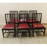 A set of six stick back dining chairs with red vinyl seats.