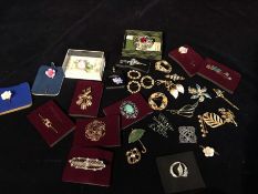 A selection of costume jewellery to include brooches, tie pins, scarves etc.