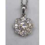 An 18ct white gold diamond daisy style pendant necklace of 1/2ct