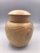 A Japanese turned wooden lidded jar.