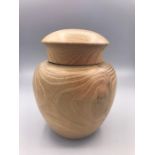 A Japanese turned wooden lidded jar.