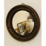 A Regency style, convex porthole style mirror. (AF)