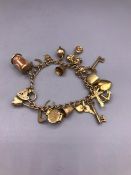 A 9ct yellow gold charm bracelet (31.7g)