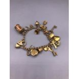 A 9ct yellow gold charm bracelet (31.7g)