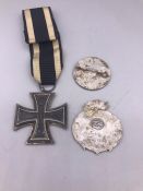 A WWI German Iron Cross and two Third Reich Badges as Found