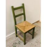 A Green, rush seated chair.