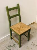A Green, rush seated chair.