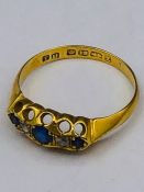 An 18ct gold ring with sapphires and diamonds