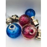 Two sets of cerise and aqua glass and white metal curtain pole finials