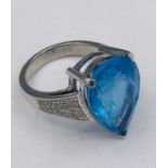 A White Gold Substantial Pear Shaped blue Topaz and diamond ring