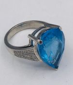 A White Gold Substantial Pear Shaped blue Topaz and diamond ring