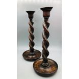 A Pair of antique twisted oak candlesticks