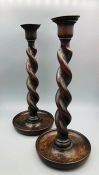 A Pair of antique twisted oak candlesticks