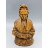 A carved image of a lady.