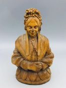 A carved image of a lady.