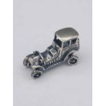 A silver model of a vintage car