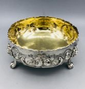 A hallmarked silver bowl on three lion feet