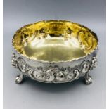 A hallmarked silver bowl on three lion feet