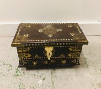 A Persian leather and brass detailed box.