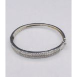 A Substantial silver and CZ bangle