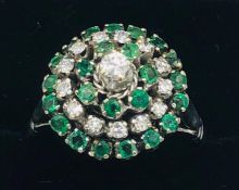 An 18ct white gold emerald and diamond halo style ring of 1.2ct's approx.