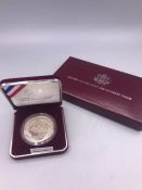 A Cased Silver proof 1988 Olympic coin (USA)