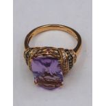 A 14ct Rose Gold substantial amethyst and diamond ring