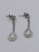 A Pair of silver CZ and Opal drop earrings