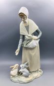 Lladro figure of a woman feeding rabbits