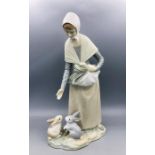 Lladro figure of a woman feeding rabbits