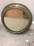 A Brass porthole style mirror with etched design. AF