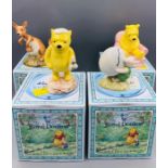 A selection of four Royal Doulton Winnie The Pooh china figures boxed.