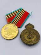 Two Military items a Canadian Light Infantry Cap Badge and a Polish medal.