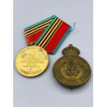 Two Military items a Canadian Light Infantry Cap Badge and a Polish medal.