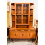 A Mid Century Display Cabinet with display shelves, glass fronted cabinets and cupboards.